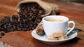 Coffee cup with Coffee beans, burlap sack and with cinnamon sticks Royalty Free Stock Photo