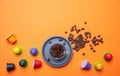 Coffee cup, beans and capsules on orange color background, copy space, top view Royalty Free Stock Photo