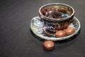 Coffee cup, beans, chocolate and macaroons on old kitchen table Royalty Free Stock Photo