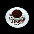 Coffee cup with coffee beans closeup shot on black background Royalty Free Stock Photo