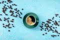 Coffee cup and coffee beans, overhead flat lay shot on a blue background Royalty Free Stock Photo