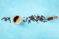 Coffee cup and beans, overhead flat lay shot on a blue background Royalty Free Stock Photo