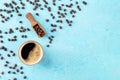 Coffee cup and beans, shot from the top on a blue background with copy space Royalty Free Stock Photo