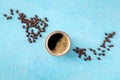 Coffee cup and beans, top shot on a blue background with copy space Royalty Free Stock Photo