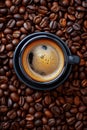 Coffee cup with coffee beans top view. Cup of freshly brewed espresso closeup on roasted coffee beans background Royalty Free Stock Photo