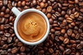 Coffee cup with coffee beans top view. Cup of freshly brewed espresso closeup on roasted coffee beans background Royalty Free Stock Photo