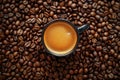 Coffee cup with coffee beans top view. Cup of freshly brewed espresso closeup on roasted coffee beans background Royalty Free Stock Photo