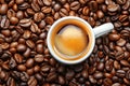 Coffee cup with coffee beans top view. Cup of freshly brewed espresso closeup on roasted coffee beans background Royalty Free Stock Photo