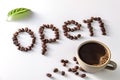 Coffee cup and coffee beans on white background with open Text made of coffee beans Royalty Free Stock Photo