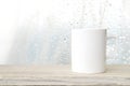 Coffee cup and beans on wood table over blurred tree background Royalty Free Stock Photo