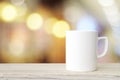 Coffee cup and beans on wood table over blurred tree background Royalty Free Stock Photo