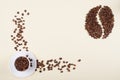 Coffee cup and big coffee bean made of scattered beans. Royalty Free Stock Photo