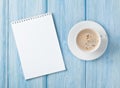 Coffee cup and blank notepad