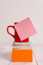 Front view coffee cup blank colored sticky note stacked note pads square box lying retro vintage rustic old table Royalty Free Stock Photo