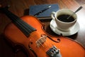 Coffee cup with book,pen and violin.