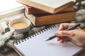 Coffee Cup with Book and Woman Hand Wrting on White Book with V