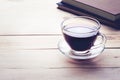 Coffee cup with book on wood table in morning Royalty Free Stock Photo