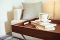 Coffee cup Books on table wooden tray Pillow on sofa Home Interior Royalty Free Stock Photo