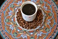 Coffee cup on burlap sack with roasted beans Royalty Free Stock Photo