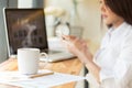 Coffee cup and Businesswoman working with documents and laptop Royalty Free Stock Photo