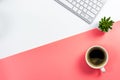 Coffee cup with cactus pot and computer keyboard on white and pink background Royalty Free Stock Photo