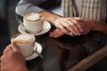 Coffee cup, cafe and relax couple holding hands for support, empathy and care on morning date with caffeine beverage