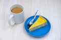 Coffee cup and cake on plate photo on white wooden table. Tea time concept. Buko pie recipe photo for cook book