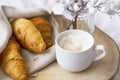 Coffee cup cappuccino with cream and baked croissants. Morning breafast with croissants buns and fresh coffee Royalty Free Stock Photo