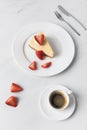 Coffee cup with cheesecake and sliced strawberries Royalty Free Stock Photo