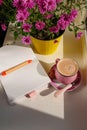 Coffee cup chocolate notebook beautiful pink autumn Chrysanthemum flowers in yellow pot on window. Cozy home Royalty Free Stock Photo