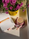 Coffee cup chocolate notebook beautiful pink autumn Chrysanthemum flowers in yellow pot on window. Cozy home Royalty Free Stock Photo