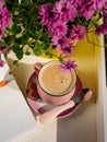Coffee cup chocolate notebook beautiful pink autumn Chrysanthemum flowers in yellow pot on window. Cozy home Royalty Free Stock Photo