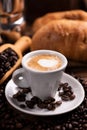 Coffee cup over dark roasted coffee beans Royalty Free Stock Photo