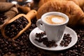 Coffee cup over dark roasted coffee beans Royalty Free Stock Photo