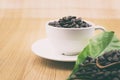 Coffee cup with coffee beans and coffee leaves Royalty Free Stock Photo