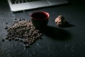 Coffee cup and coffee beans and cookie and laptop on black background Royalty Free Stock Photo