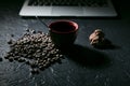 Coffee cup and coffee beans and cookie and laptop on black background Royalty Free Stock Photo