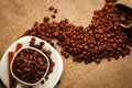 Coffee cup and coffee beans on a wooden table and sack background, Vintage color tone Royalty Free Stock Photo