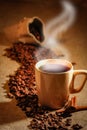 Coffee cup and coffee beans on a wooden table and sack background, Vintage color tone Royalty Free Stock Photo