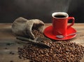 Coffee cup and coffee beans on wooden table Royalty Free Stock Photo