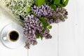 Coffee cup and colorful lilac flowers on garden table Royalty Free Stock Photo