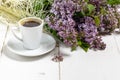 Coffee cup and colorful lilac flowers on garden table Royalty Free Stock Photo