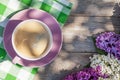 Coffee cup and colorful lilac flowers on garden table Royalty Free Stock Photo