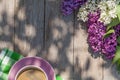 Coffee cup and colorful lilac flowers on garden table Royalty Free Stock Photo