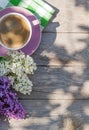 Coffee cup and colorful lilac flowers on garden table Royalty Free Stock Photo