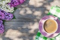 Coffee cup and colorful lilac flowers on garden table Royalty Free Stock Photo