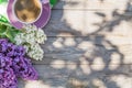 Coffee cup and colorful lilac flowers on garden table Royalty Free Stock Photo