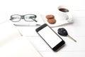 coffee cup with cookie,phone,open notebook,car key and eyeglasses Royalty Free Stock Photo