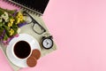 Coffee cup with cookies, alarm clock, flowers, on pink background composition Royalty Free Stock Photo