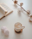 coffee cup, cotton flower, open book on a white table background top view Royalty Free Stock Photo